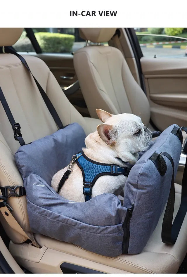 French bulldog wearing a body harness in a Nuzzigo bed on a car seat