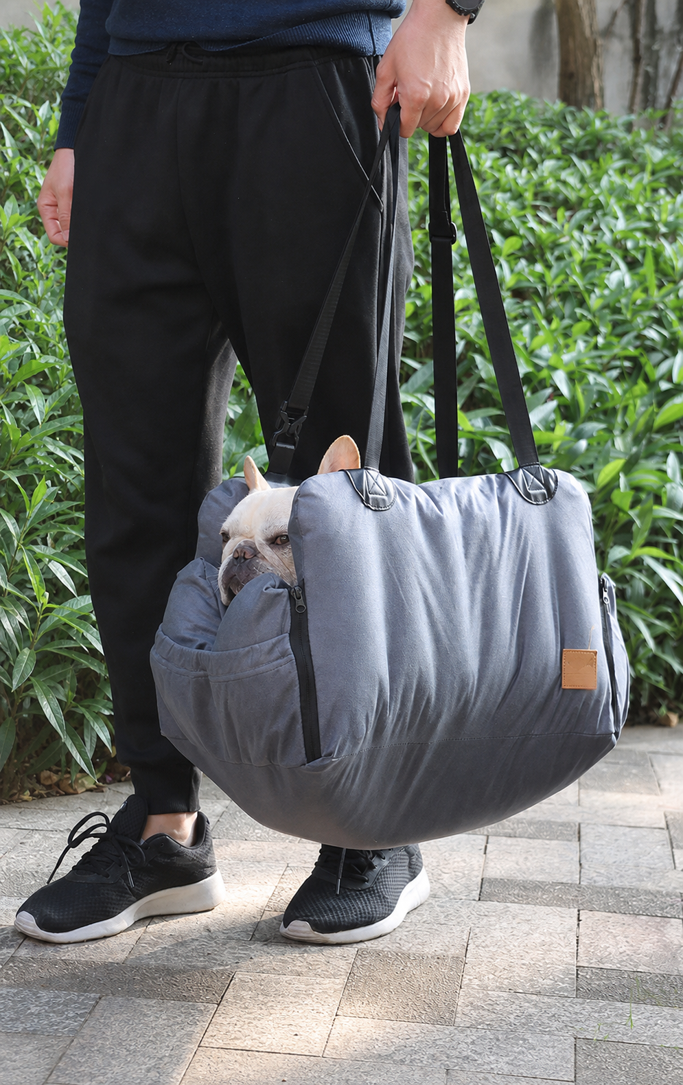 The gray Nuzzigo Everywhere Bed folded for easy carrying